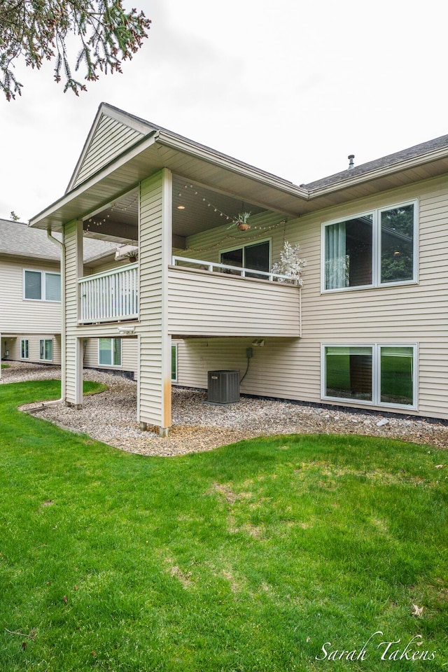 rear view of house featuring a yard and cooling unit