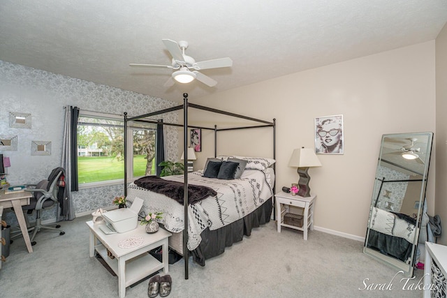 carpeted bedroom with baseboards and a ceiling fan
