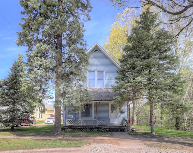view of front of house with a porch and a front lawn