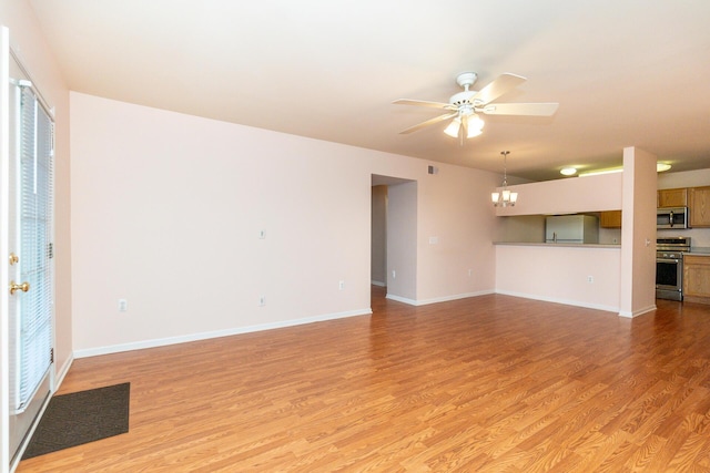 unfurnished living room with light wood-style floors, baseboards, and ceiling fan with notable chandelier