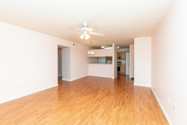unfurnished living room with light wood-type flooring, a ceiling fan, and baseboards