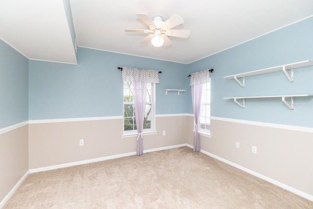 spare room with baseboards, carpet, and ceiling fan
