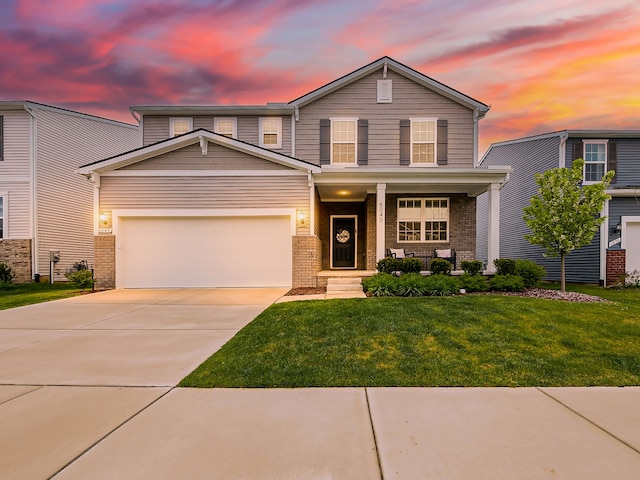 view of front of property featuring covered porch, concrete driveway, a front yard, brick siding, and an attached garage