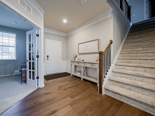 entrance foyer featuring stairs, wood finished floors, ornamental molding, and recessed lighting