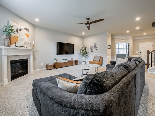 carpeted living room with ceiling fan, a fireplace, recessed lighting, ornamental molding, and baseboards