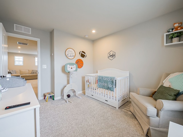 carpeted bedroom with a nursery area, baseboards, and recessed lighting