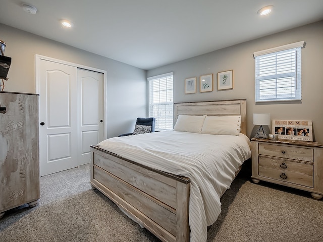 carpeted bedroom featuring multiple windows, a closet, and recessed lighting