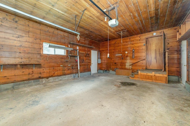 garage with wooden ceiling, a garage door opener, and wood walls