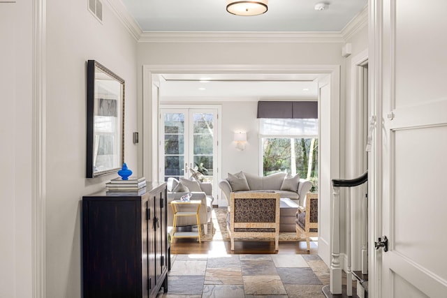 living area with dark wood-style flooring, visible vents, and ornamental molding