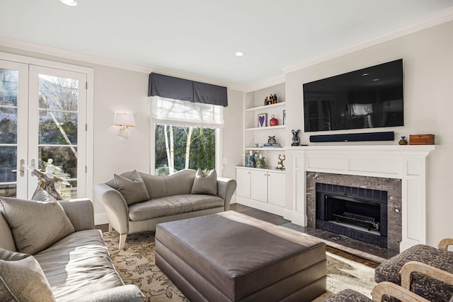 living area with recessed lighting, light wood-style floors, ornamental molding, and a high end fireplace