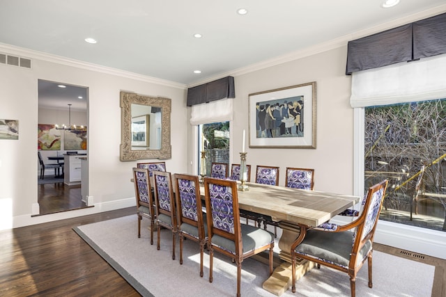 dining space with visible vents, crown molding, wood finished floors, recessed lighting, and a chandelier