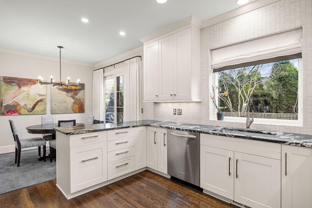 kitchen with crown molding, dark stone counters, a peninsula, and dishwasher