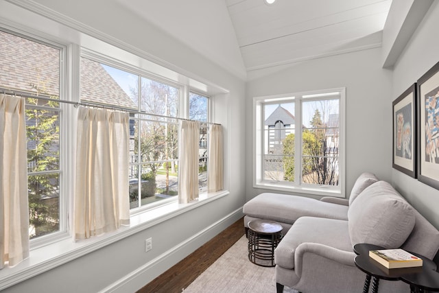 sitting room featuring dark wood-style flooring, baseboards, and vaulted ceiling