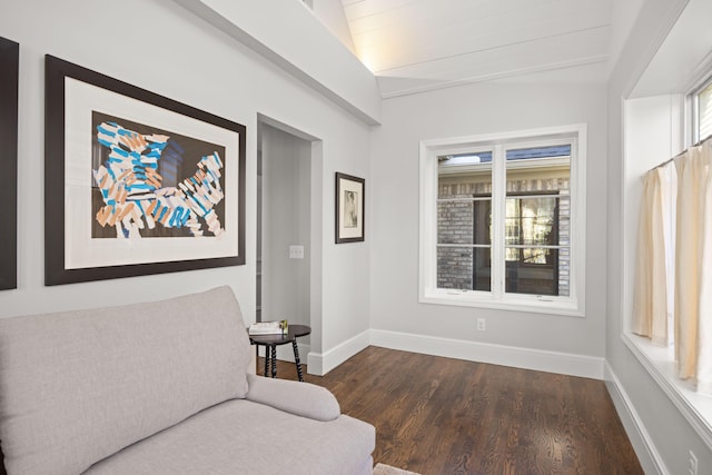 sitting room featuring baseboards, dark wood finished floors, and vaulted ceiling