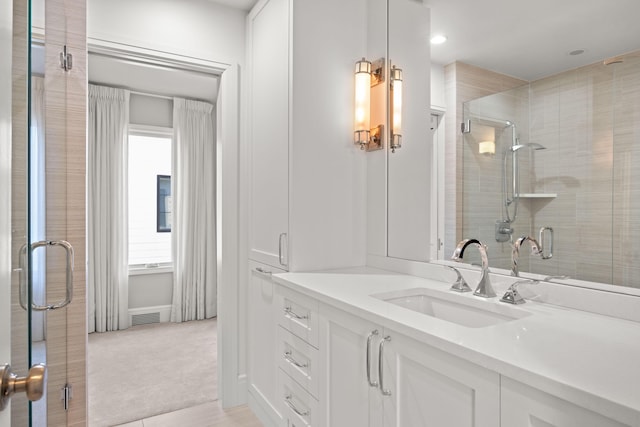 bathroom featuring recessed lighting, visible vents, a shower stall, and vanity