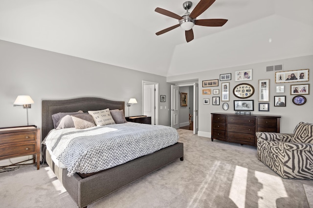 bedroom featuring a ceiling fan, light carpet, lofted ceiling, and visible vents