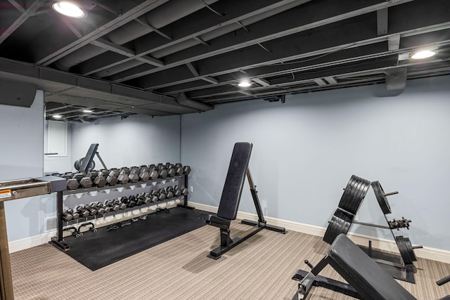 workout area featuring baseboards and carpet flooring