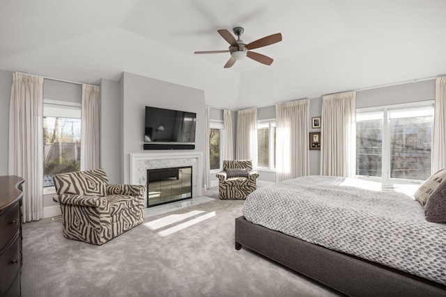 carpeted bedroom with ceiling fan, a premium fireplace, and lofted ceiling