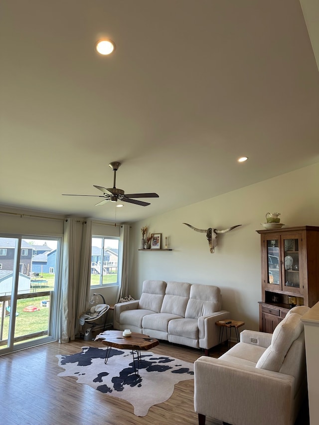 living area with a ceiling fan, recessed lighting, and wood finished floors