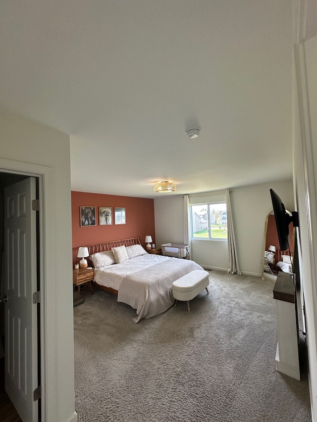 bedroom with carpet flooring and baseboards