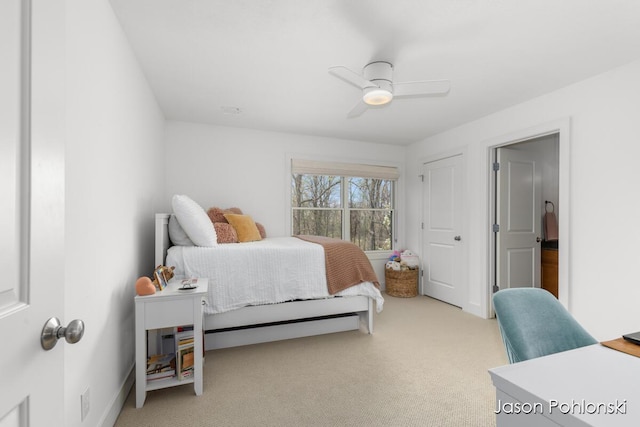 bedroom with a ceiling fan and light colored carpet