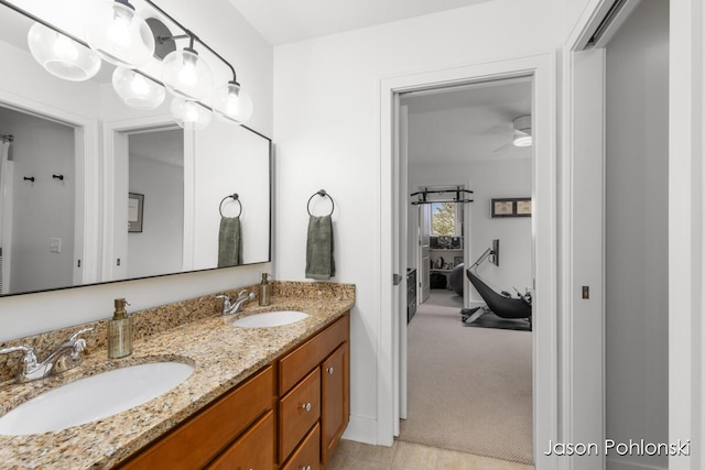 bathroom featuring a sink, a ceiling fan, and double vanity