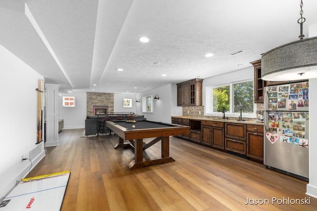 playroom with a stone fireplace, recessed lighting, billiards, visible vents, and hardwood / wood-style flooring