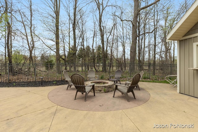 view of patio featuring a fenced backyard and a fire pit
