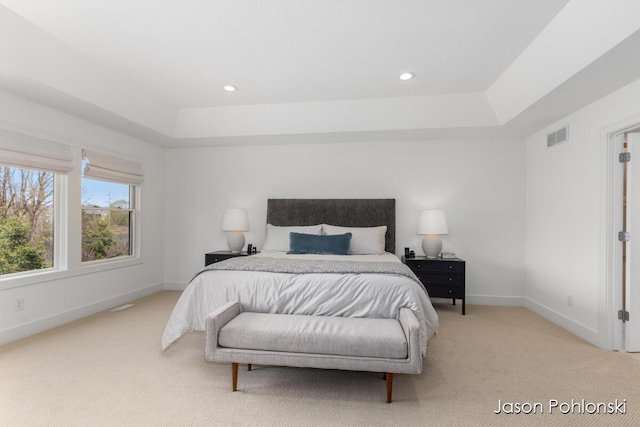 bedroom featuring visible vents, light colored carpet, baseboards, a raised ceiling, and recessed lighting