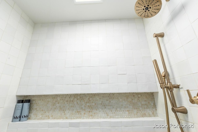 bathroom with a tile shower