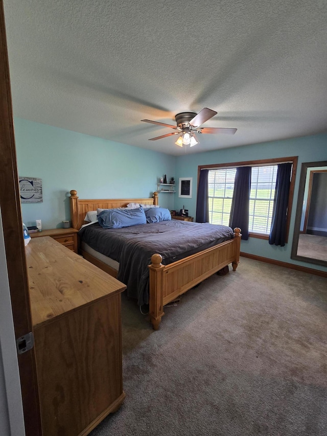 bedroom featuring carpet floors, a ceiling fan, a textured ceiling, and baseboards