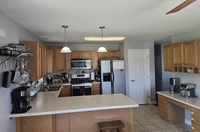 kitchen with a sink, light countertops, and stainless steel appliances