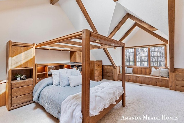 bedroom featuring visible vents, wainscoting, wooden walls, vaulted ceiling with beams, and carpet flooring