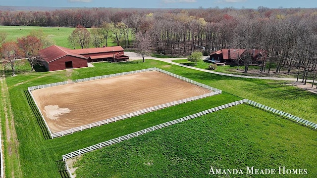 aerial view featuring a rural view and a wooded view
