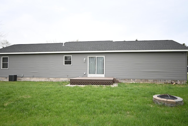 back of house featuring a lawn, crawl space, a fire pit, and a deck