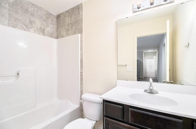 bathroom featuring toilet, shower / washtub combination, and vanity
