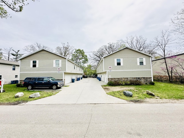 1201 Kimbark Ave, Kalamazoo, MI 49006 - exterior space featuring a garage, a yard, and concrete driveway