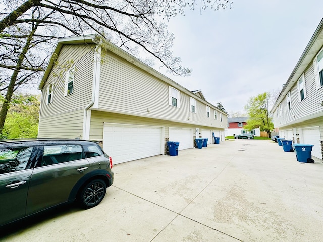 1201 Kimbark Ave, Kalamazoo, MI 49006 - view of side of property with a residential view, an attached garage, and concrete driveway
