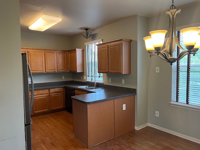 5 Bradford, Dearborn, MI 48126 - kitchen featuring a sink, freestanding refrigerator, dishwasher, dark countertops, and a peninsula