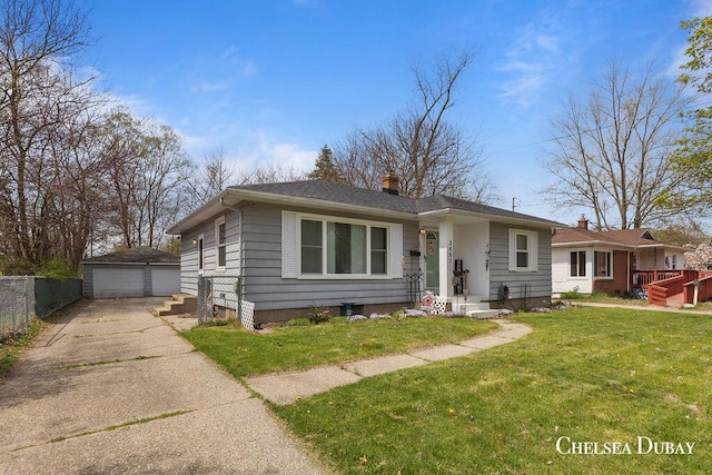 bungalow-style home featuring fence, a front lawn, a garage, an outbuilding, and a chimney