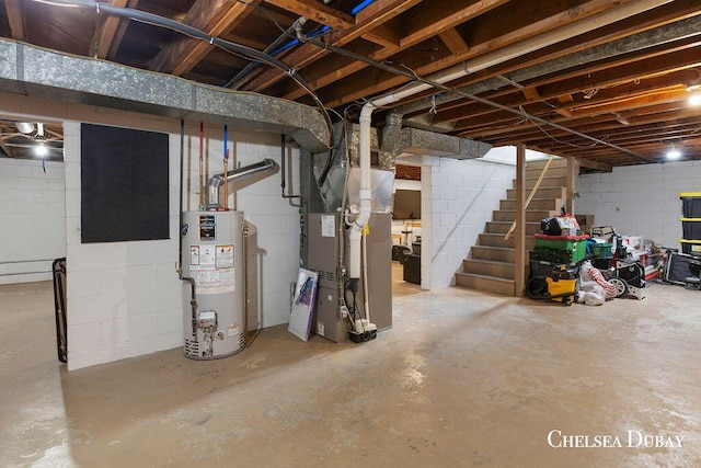 unfinished below grade area with stairway, concrete block wall, heating unit, and gas water heater