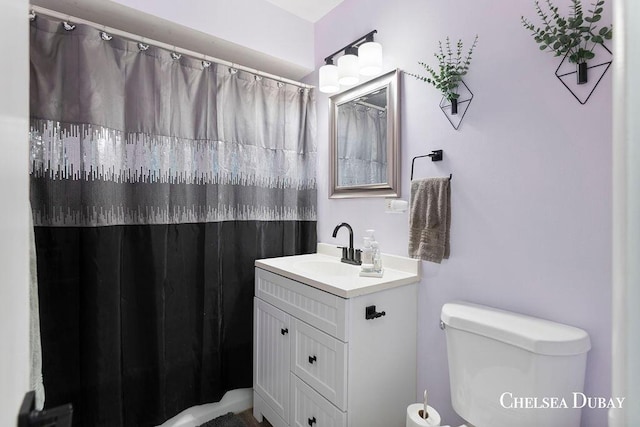 bathroom with vanity, a shower with shower curtain, and toilet