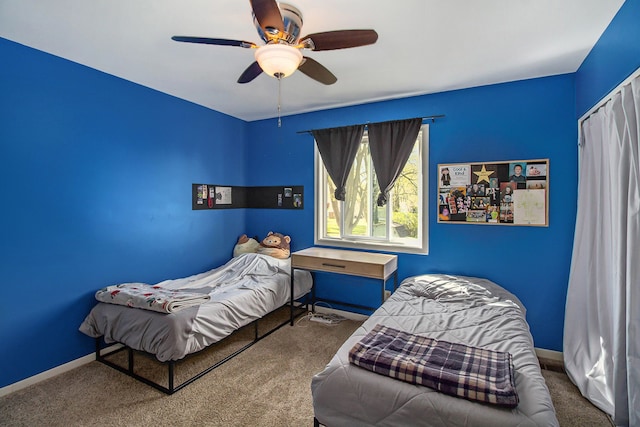 bedroom featuring carpet flooring, a ceiling fan, and baseboards