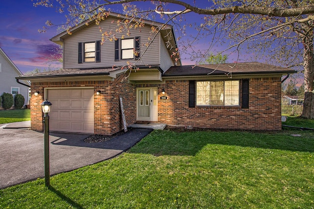 traditional home featuring brick siding, a garage, driveway, and a front yard