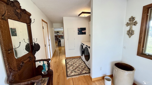 7736 S Custer Rd, Monroe, MI 48161 - washroom with baseboards, a textured ceiling, cabinet space, light wood-style flooring, and independent washer and dryer