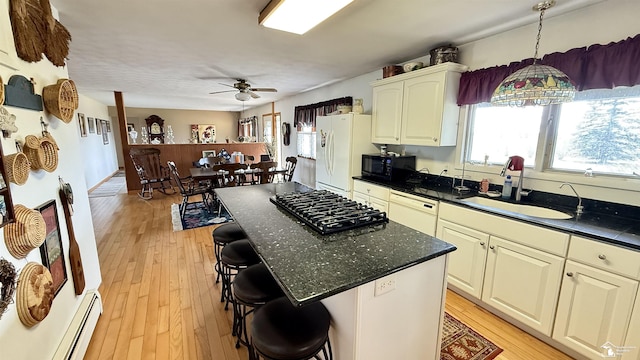 7736 S Custer Rd, Monroe, MI 48161 - kitchen with a ceiling fan, white appliances, a kitchen breakfast bar, a sink, and light wood finished floors