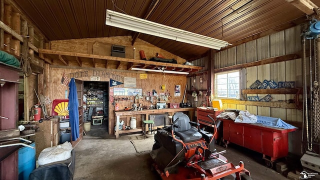 7736 S Custer Rd, Monroe, MI 48161 - misc room featuring concrete flooring, wood walls, a workshop area, and vaulted ceiling