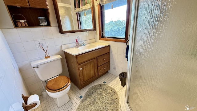 7736 S Custer Rd, Monroe, MI 48161 - full bathroom featuring tile walls, a stall shower, vanity, tile patterned floors, and toilet