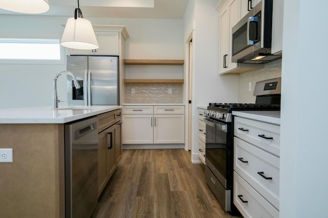 kitchen featuring light countertops, stainless steel appliances, decorative light fixtures, decorative backsplash, and dark wood-type flooring