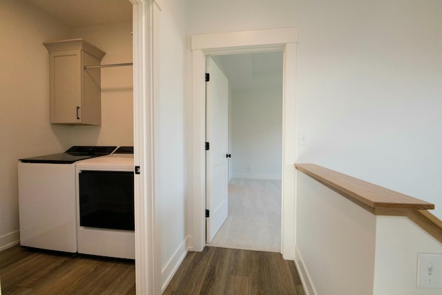 washroom featuring baseboards, dark wood-style floors, and washer / clothes dryer